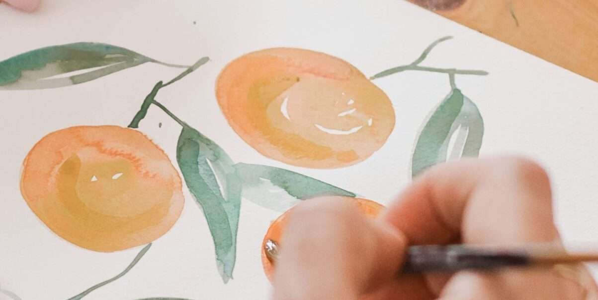 person painting a orange fruits